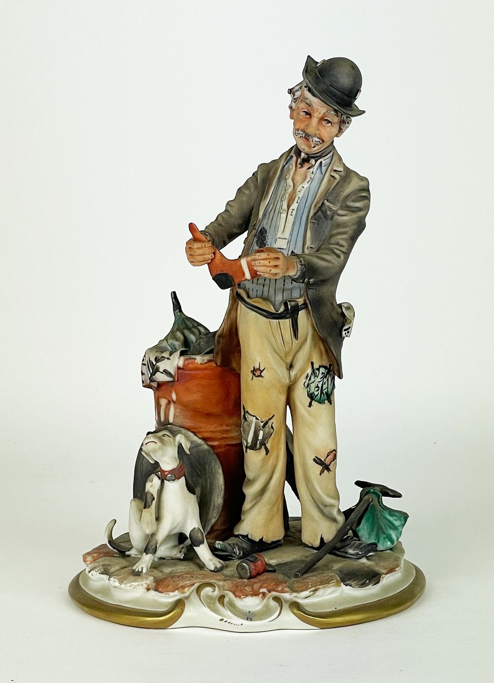 Polychrome artistic porcelain, marked Capodimonte, depicting a beggar accompanied by his dog in 