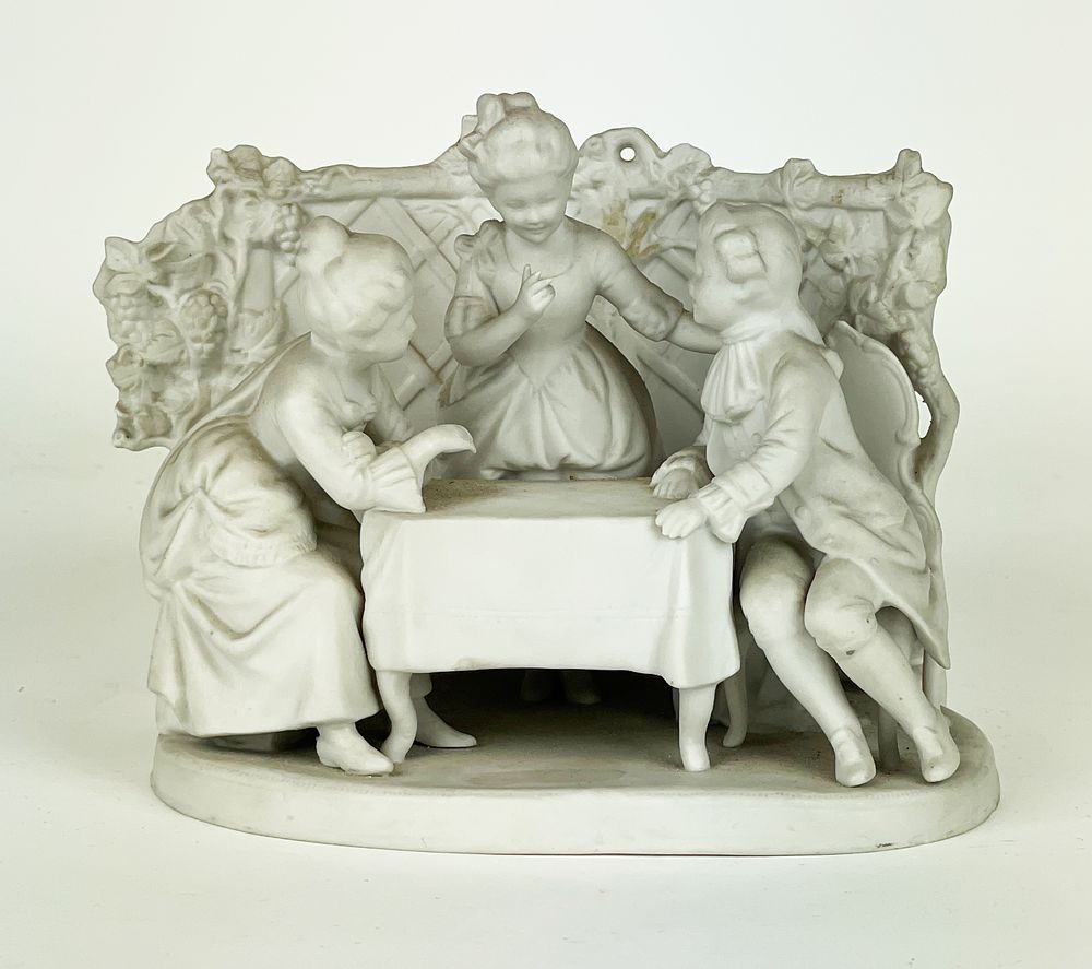 Elegant biscuit porcelain card holder depicting a scene of ladies and gentlemen.
First half of 