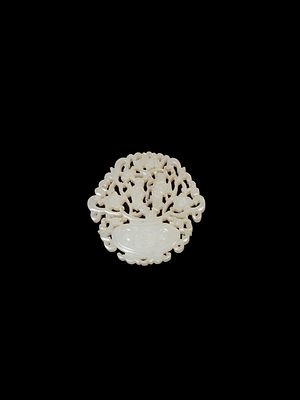 A SMALL CARVED WHITE JADE. l cm 5,2Carved and pierced, it depicts a vase from which two figures 