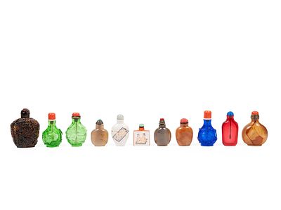 ELEVEN SNUFF BOTTLES. The larger cm 8,3Of various forms and materials: two in porcelain with 