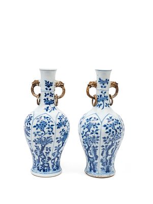 TWO BLUE AND WHITE PORCELAIN VASES. The larger h cm 24,1Bottle-shaped, with marine 