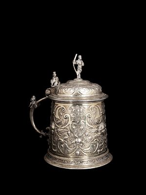 SILVER TANKARD, Germany, 18th century. h cm 16,5.Cast, shaped and gilded, it is embossed and 