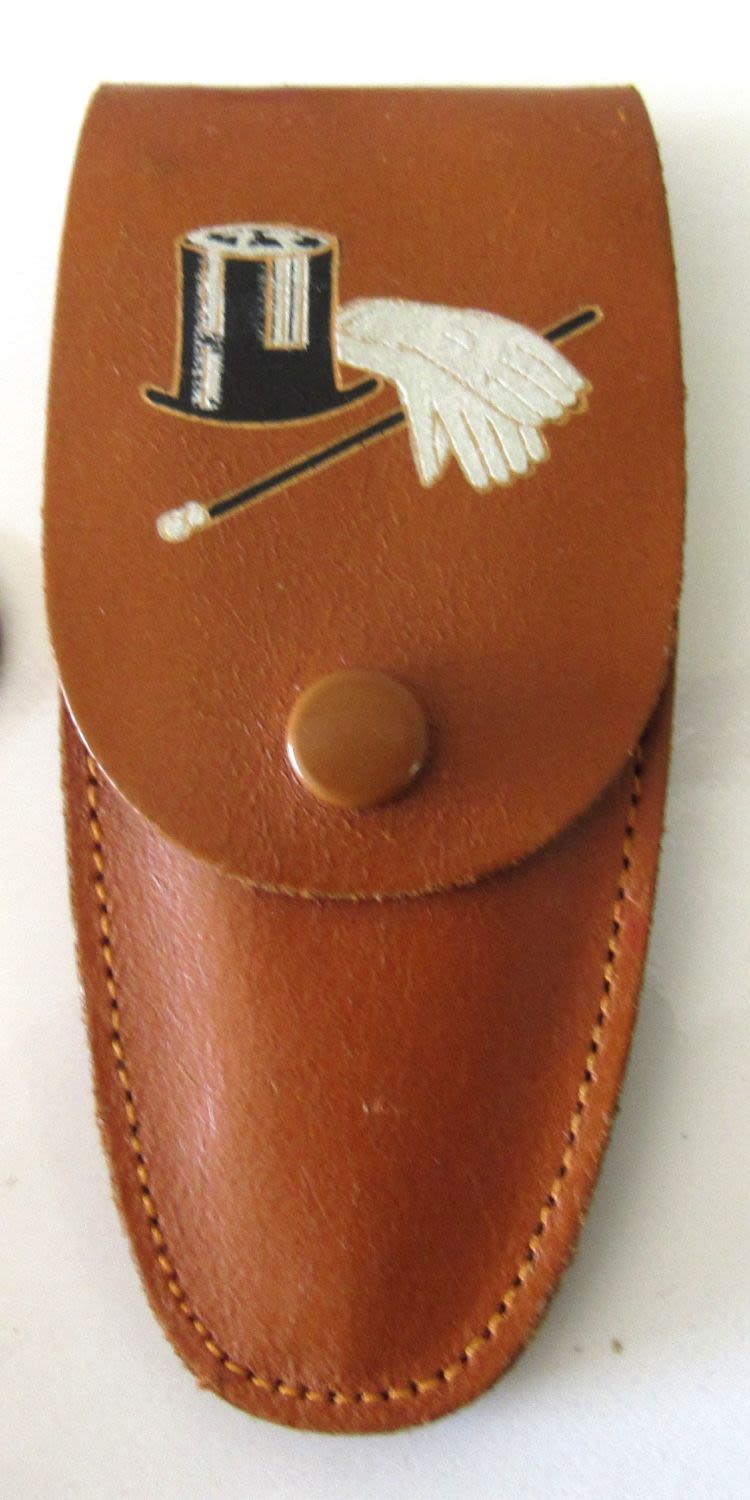 Lot 142: BOTTLE OPENER IN FANCY LEATHER CASE. C.1950S MADE IN ENGLAND.