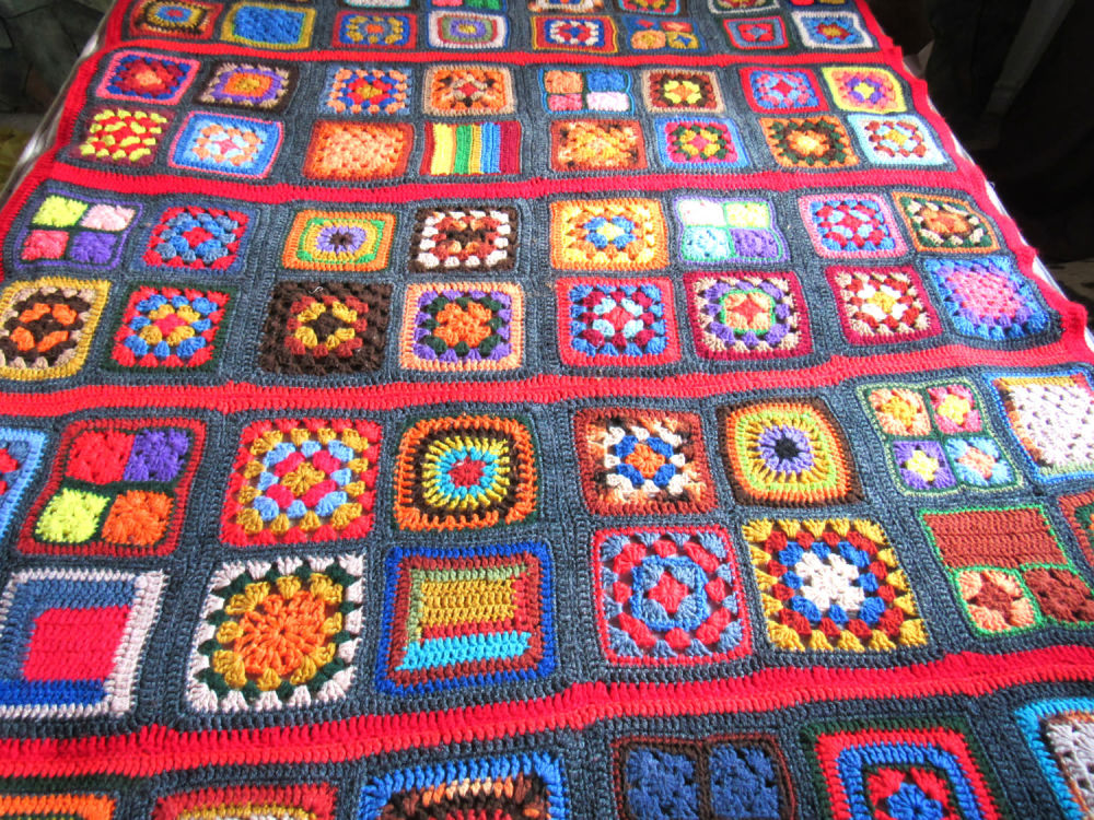 Lot 250: STUNNING VINTAGE MULTI-COLOR HAND CROCHETED QUEEN SIZE AFGHAN. FROM A BRIGHTON ESTATE. EXCELLENT CONDITION. SMOKE FREE HOME.