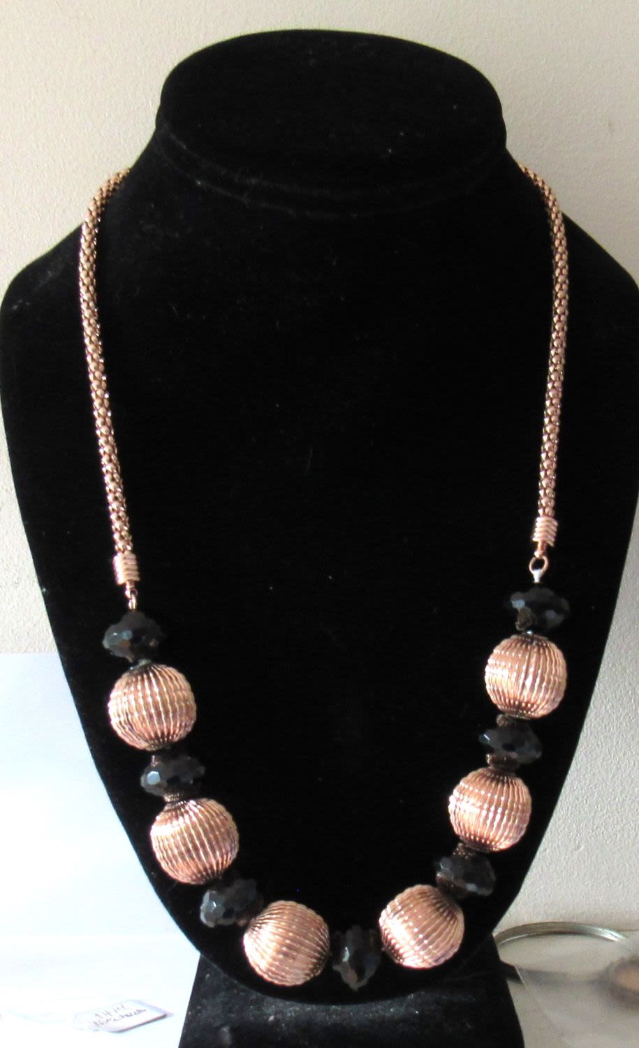 Lot 242: SIGNED HI-FASHION NECKLACE GOLDTONE WITH FACETTED GEMSTONES.NECKLACE 22.5 INCHES OVERALL LENGTH.