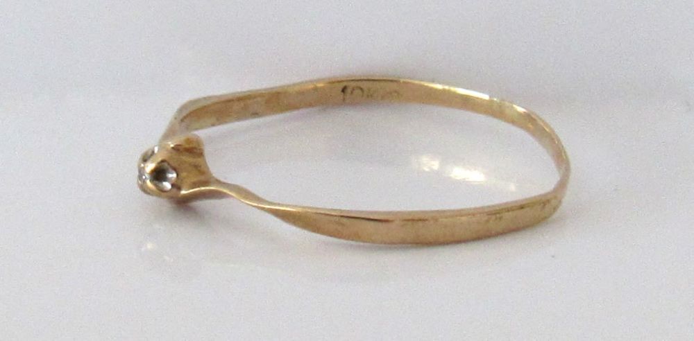 Lot 87: DAINTY 10KT GOLD DIAMOND RING. SIZE 8.25.