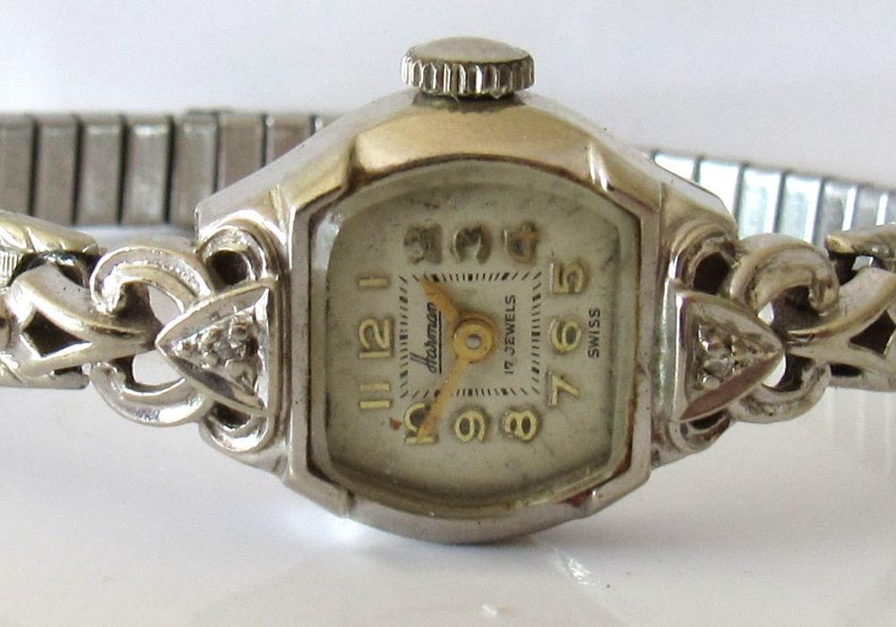 Lot 188: VINTAGE HARMAN 17JEWELS LADIES WRIST WATCH FOR REPAIR. 14KT WHITE GOLD CASE WITH SMALL SHOULDER DIAMONDS.
