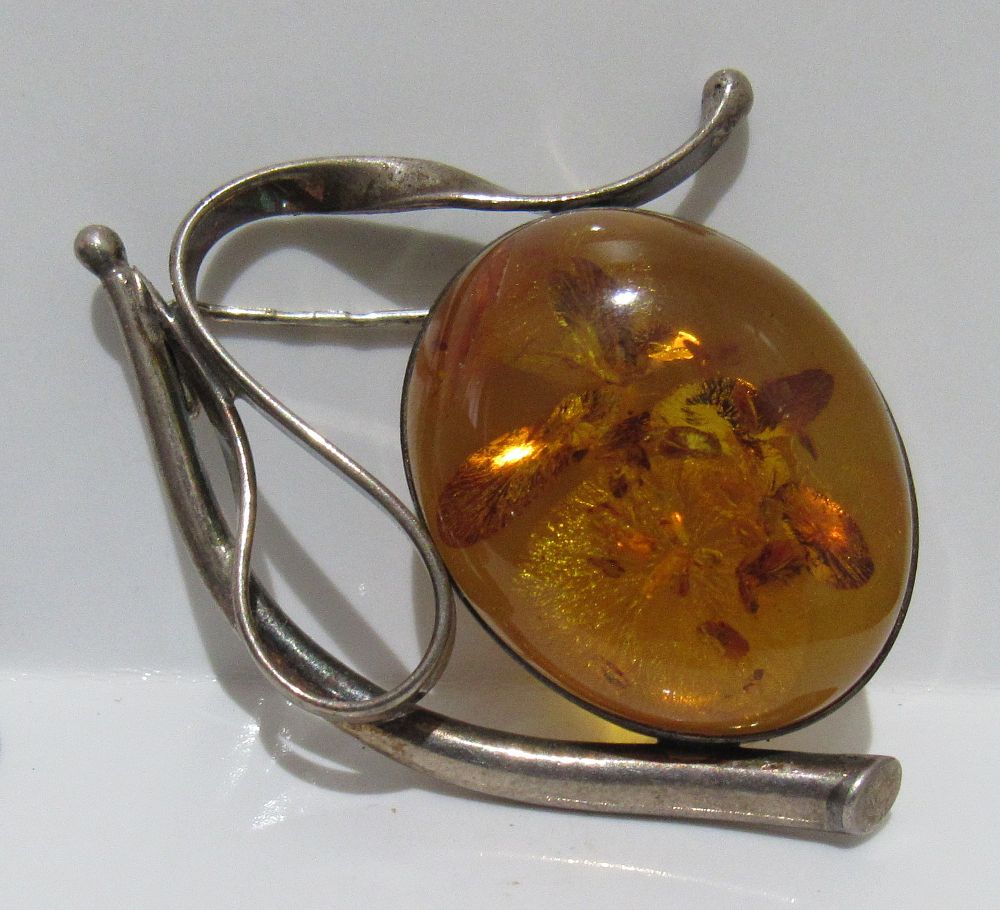 STERLING SILVER AND AMBER BROOCH.