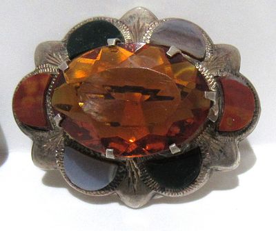 STERLING SILVER BROOCH WITH LARGE CRYSTAL SURROUNDED BY ASSORTED INSET AGATE.