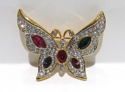 SIGNED WEEKENDERS GOLD TONE BUTTERFLY BROOCH WITH ASSORTED CRYSTALS.