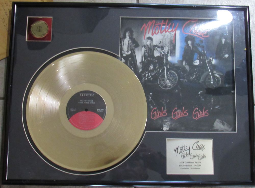 Lot 83: MOTLEY CREW FRAMED GOLD RECORD "GIRLS GIRLS GIRLS". EXCELLENT CONDITION.