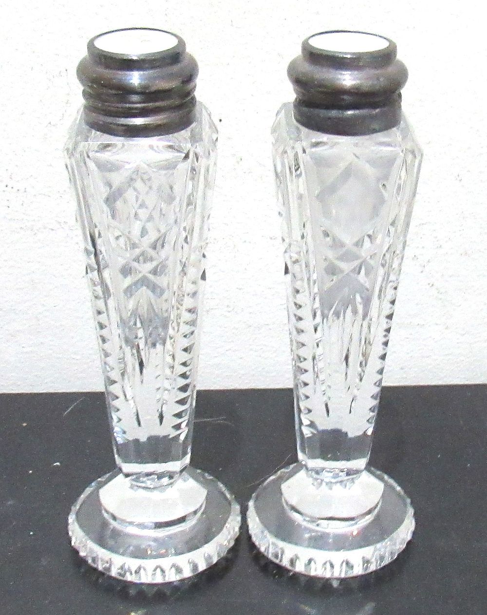 Lot 63: ELEGANT CUT CRYSTAL SALT AND PEPPER SHAKERS WITH STERLING SILVER TOPS.