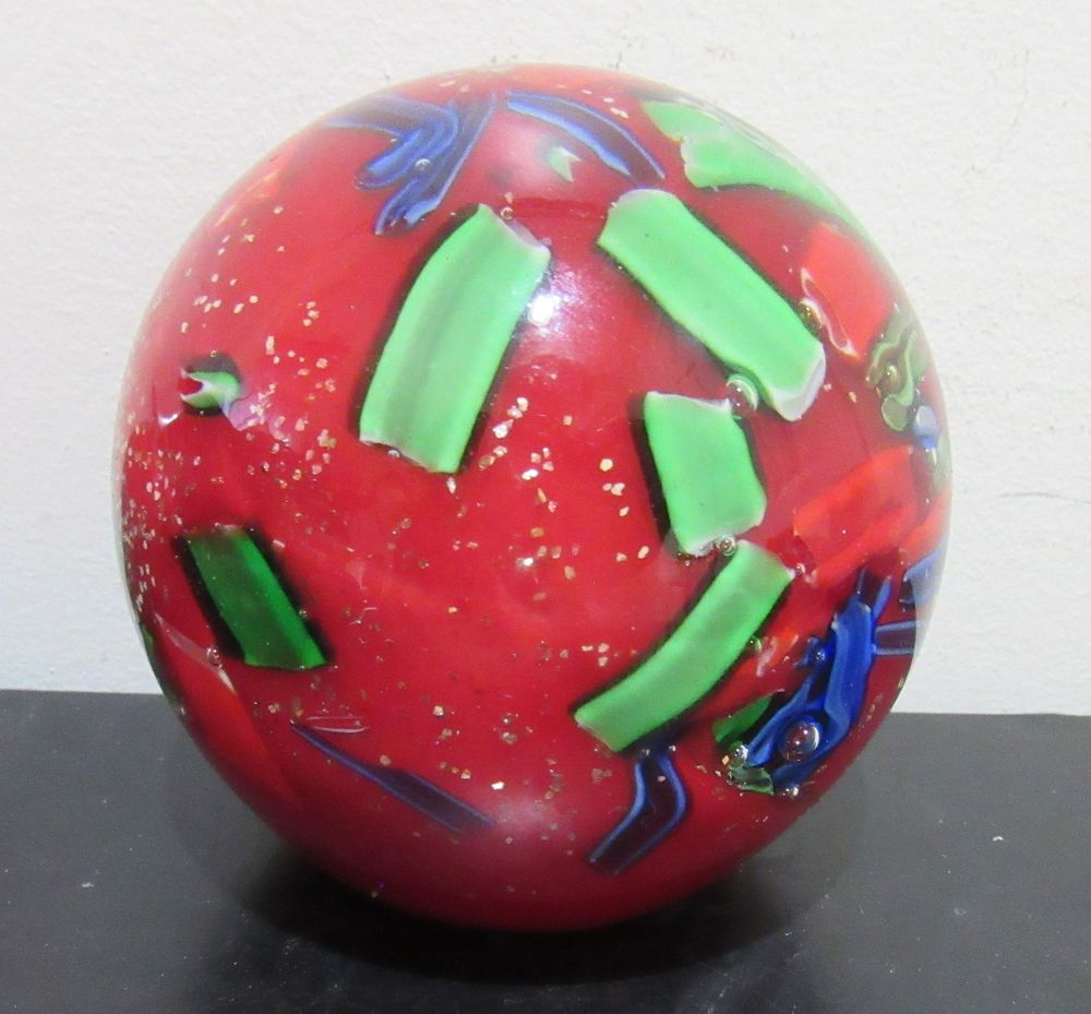 BIN PRICE $10. COLORFUL LARGE CASED GLASS PAPERWEIGHT. MINOR ROUGHAGE ON BASE.