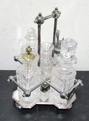 HI-GRADE LATE VICTORIAN CRUET SET WITH CUT CRYSTAL CONTAINERS. COND, NOTE. NICK ON RIM RIGHT 