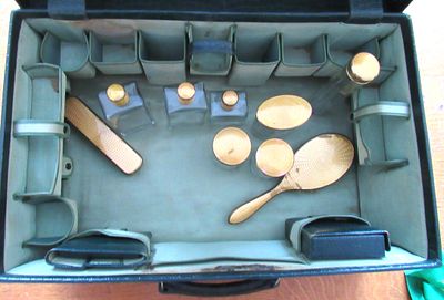 GUILLOCHE ENAMEL VANITY SET IN FITTED TRAVEL SUITCASE. COMES WITH KEYS.MINOR GUILLOCHE LOSS ON 