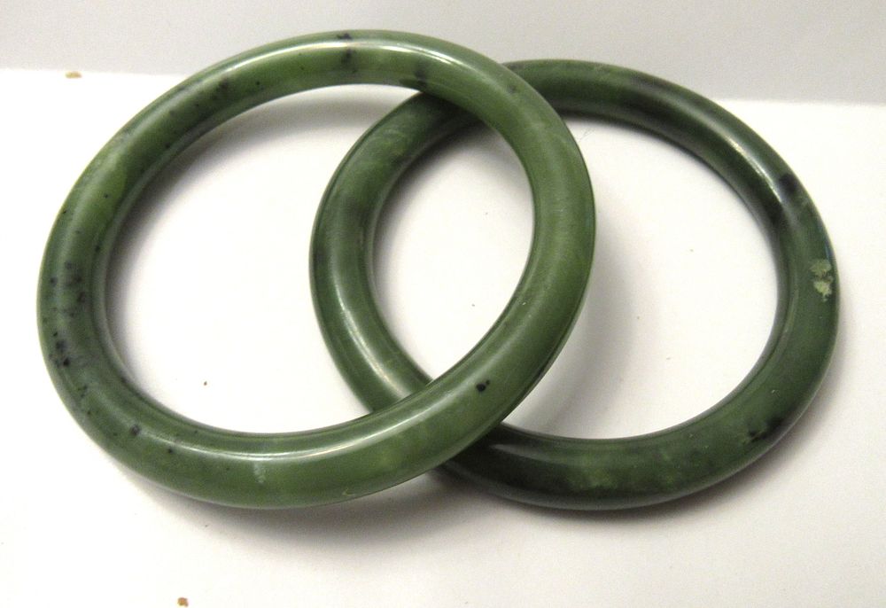 Lot 550: BUY-IT-NOW PRICE $50. PAIR OF SPINACH JADE BANGLE BRACELETS.