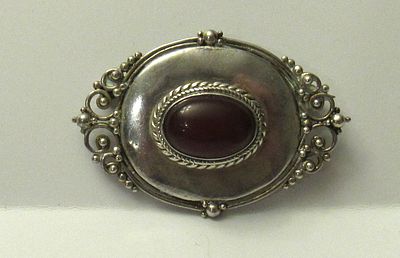 BUY-IT-NOW PRICE $45. VINTAGE STERLING SILVER BROOCH WITH CARNELIAN CABOCHON.