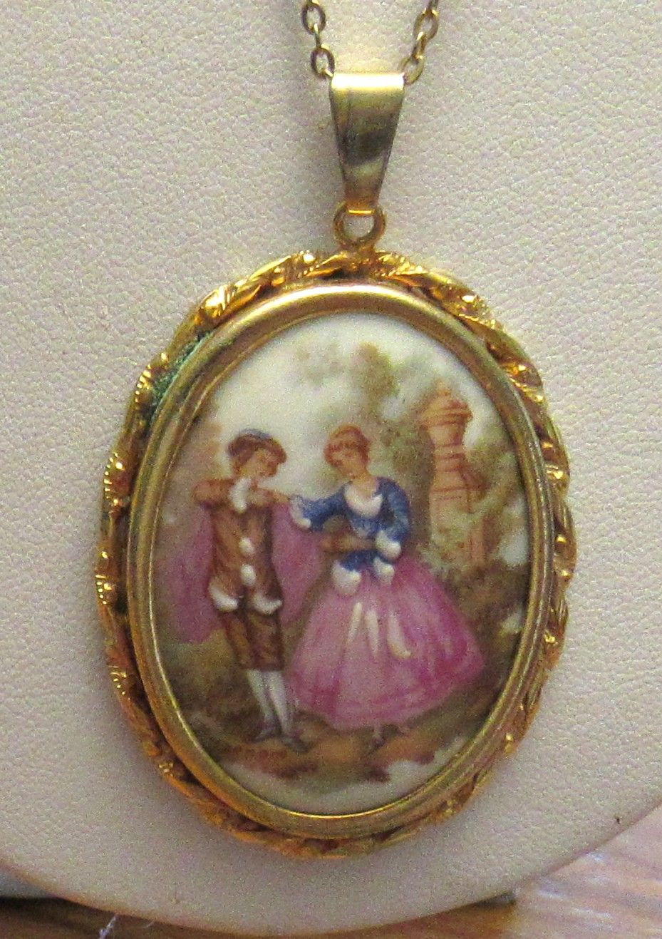 Lot 559: BUY-IT-NOW PRICE $25. LIMOGES FRANCE PENDANT IN GOLD TONE SURROUND WITH GOLD TONE CHAIN.