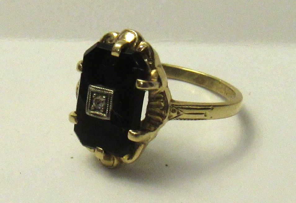 Lot 560: BUY-IT-NOW PRICE $280. BIRKS 14KT RING WITH ONYX AND PETITE DIAMOND. 3 GRAMS.
