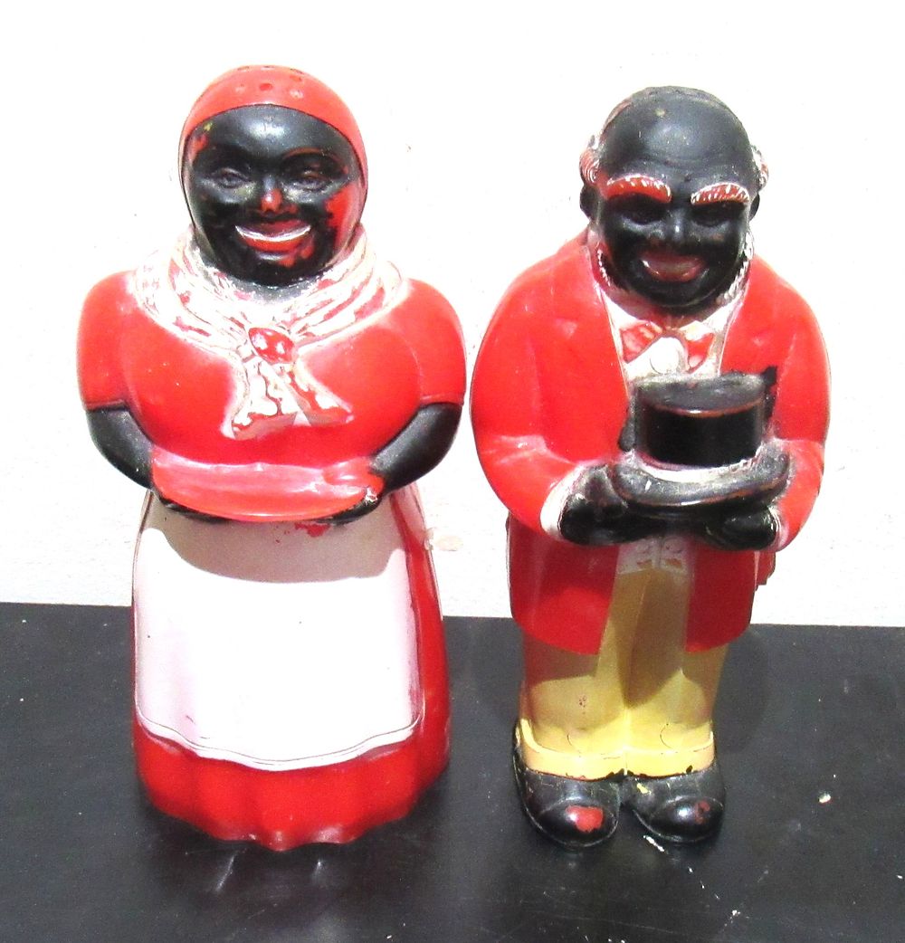 Lot 632: BUY-IT-NOW PRICE $25. BLACK AMERICANA HARD PLASTIC SALT AND PEPPER SHAKERS. EXCELLENT CONDITION WITH ORIGINAL STOPPERS.