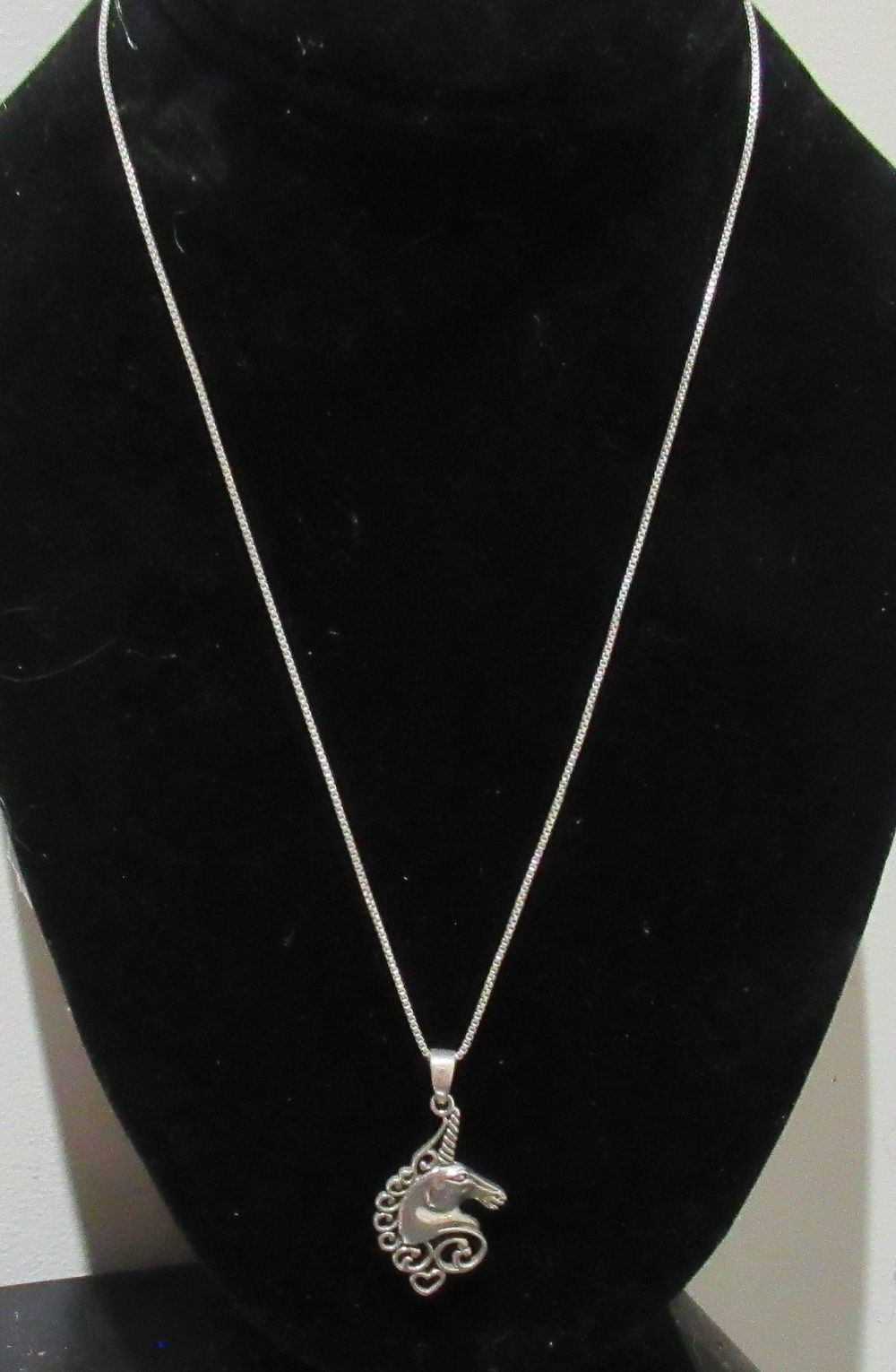 Lot 658: BUY-IT-NOW PRICE $75. STERLING SILVER NECKLACE WITH UNICORN PENDANT.