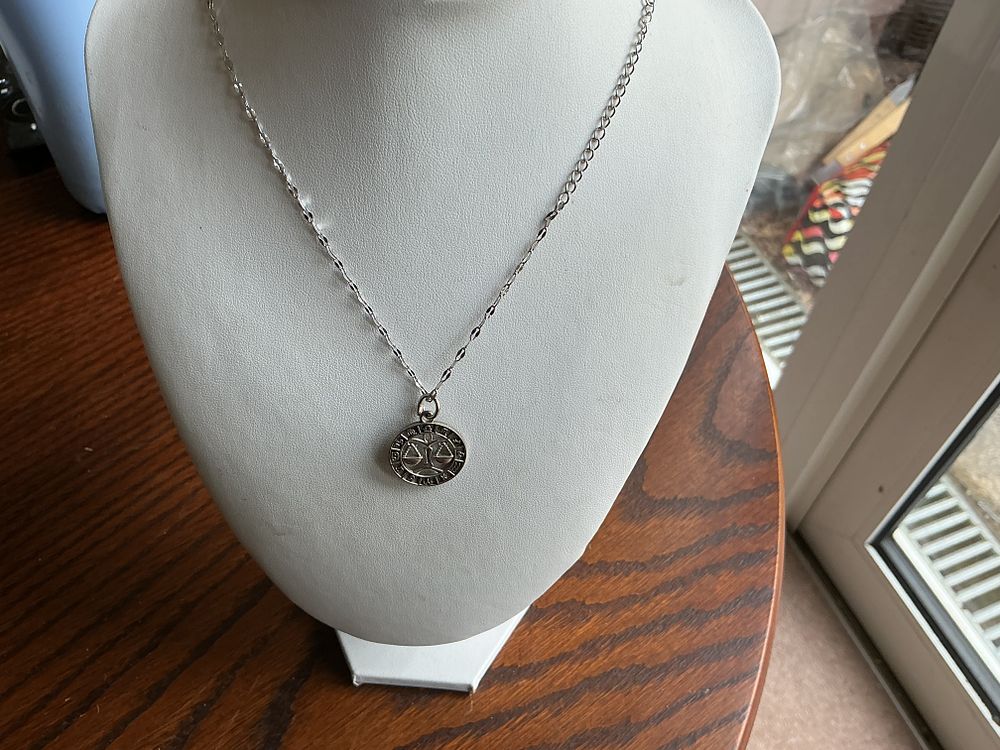 Lot 238: Libra. A Sterling Silver Libra Zodiac Pendant Necklace