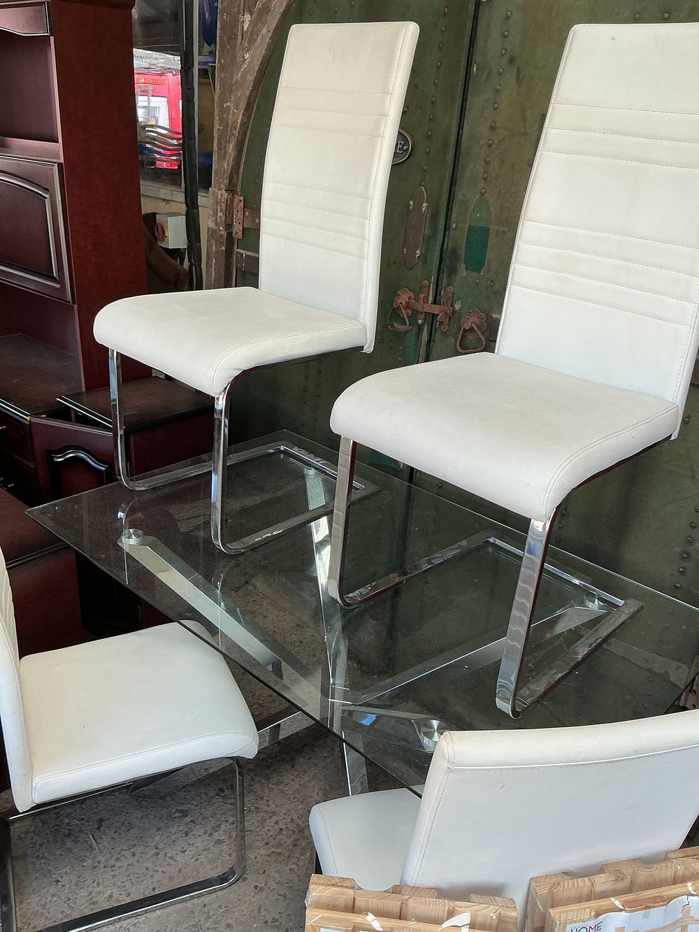 Lot 299: A Contemporary Glass Topped Dining Table and A Set of White Upholstered Cantilever Chairs
