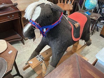 A Vintage Pegasus Rocking Horse on a Wooden Safety Stand
