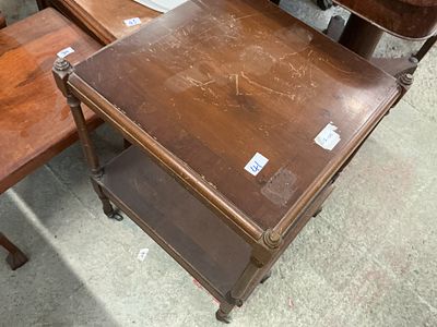 A mid-20th century Georgian style mahogany-stained two-tier occasional table on castors