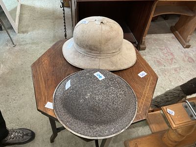 Two British Military Helmets, comprising a Wolseley Pattern Pith Helmet and a Mk II Steel 