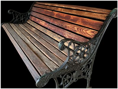 A Victorian Style Cast Iron and Wooden Garden Bench. A Victorian style garden bench featuring 