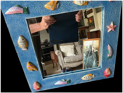 A contemporary nautical-themed wooden wall mirror with hand-painted tropical fish motifs. This 