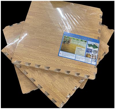 A Set of Four Packs of Wood Grain Effect Interlocking EVA Foam Floor Mats. A group of four packs 