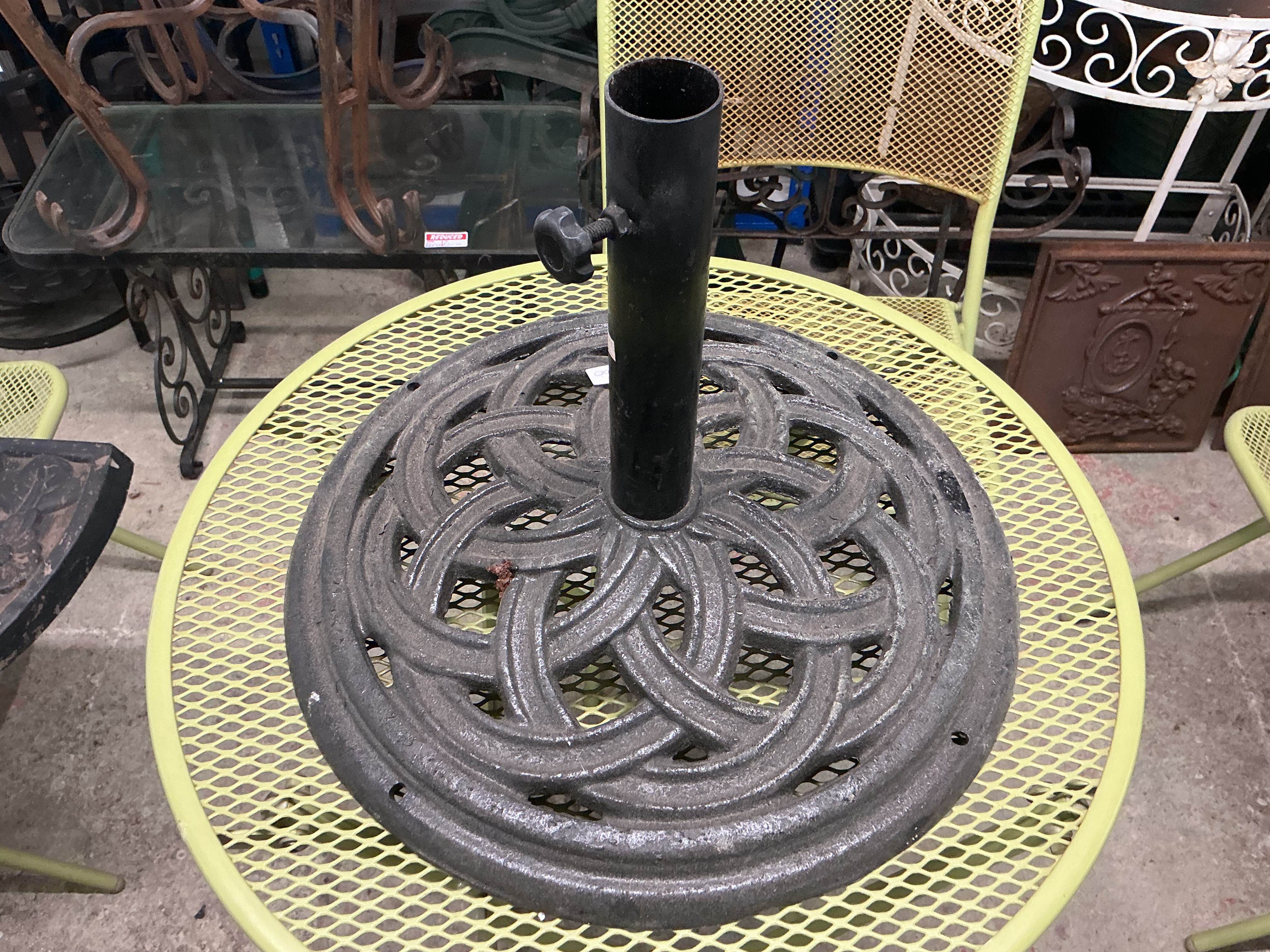 A Cast Iron Circular Parasol Base with Stylised Celtic Knot Motif