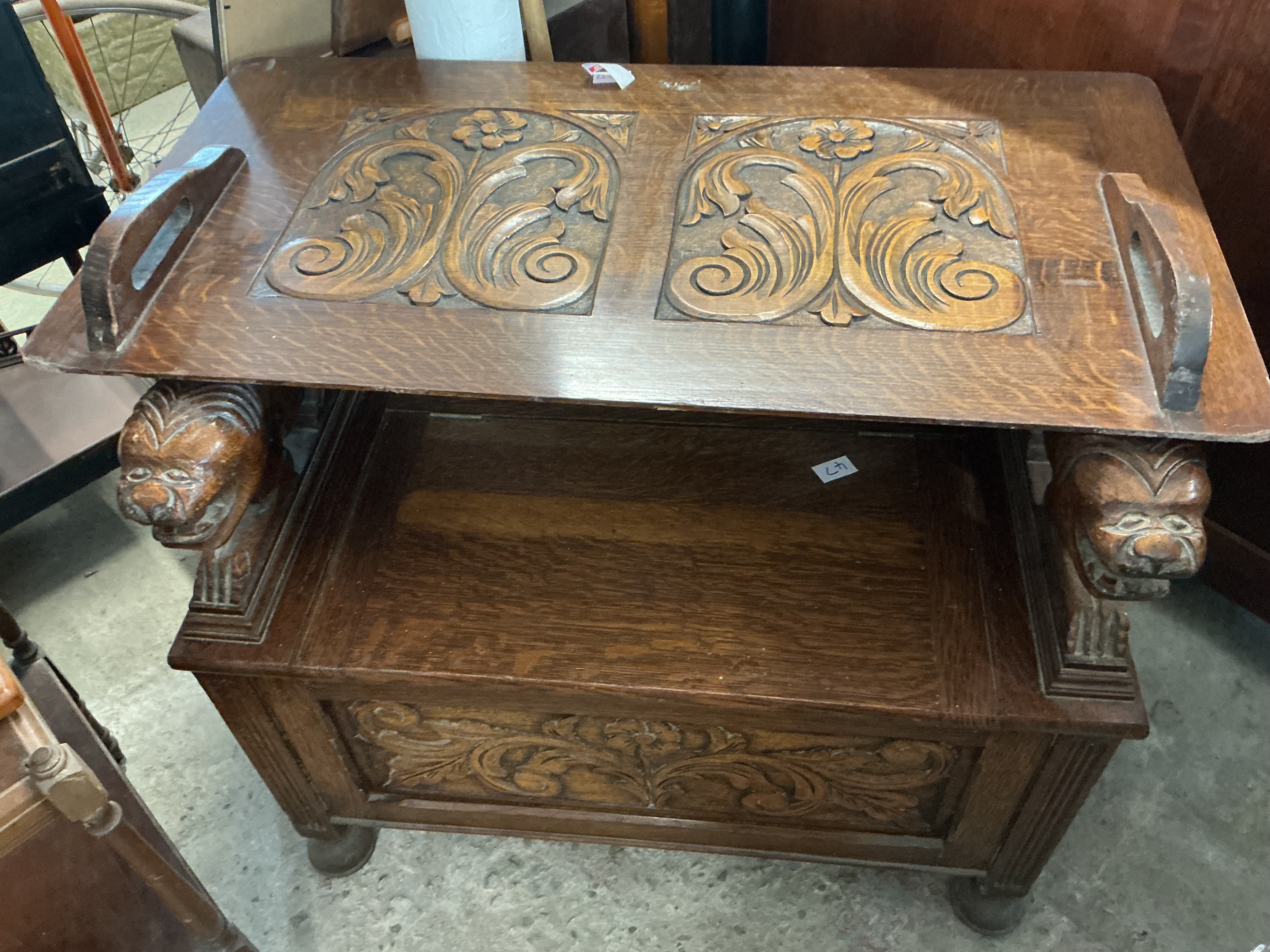 An Edwardian carved oak monks bench