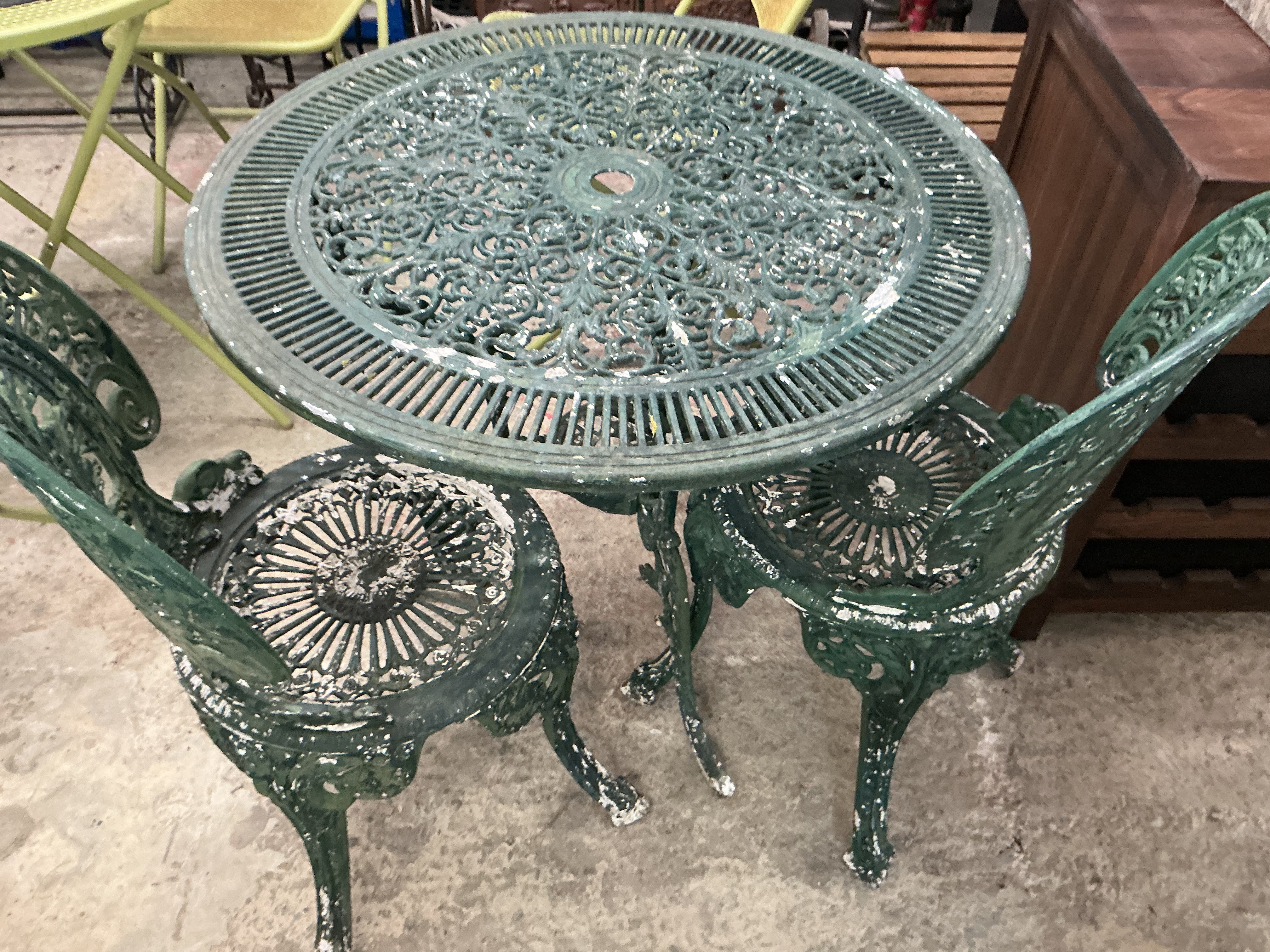 A Victorian Style Three-Piece Cast Metal Garden Bistro Set