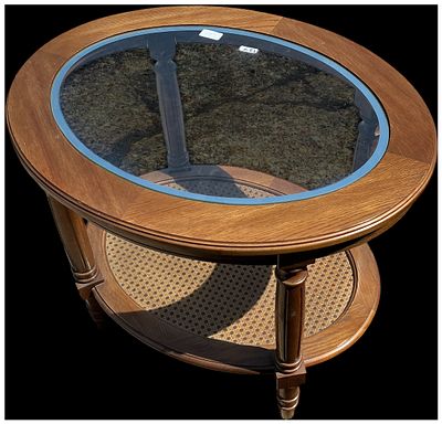 A Mid-20th Century Oval Two-Tier Glass Top and Cane Coffee Table. A mid-20th-century oval coffee 