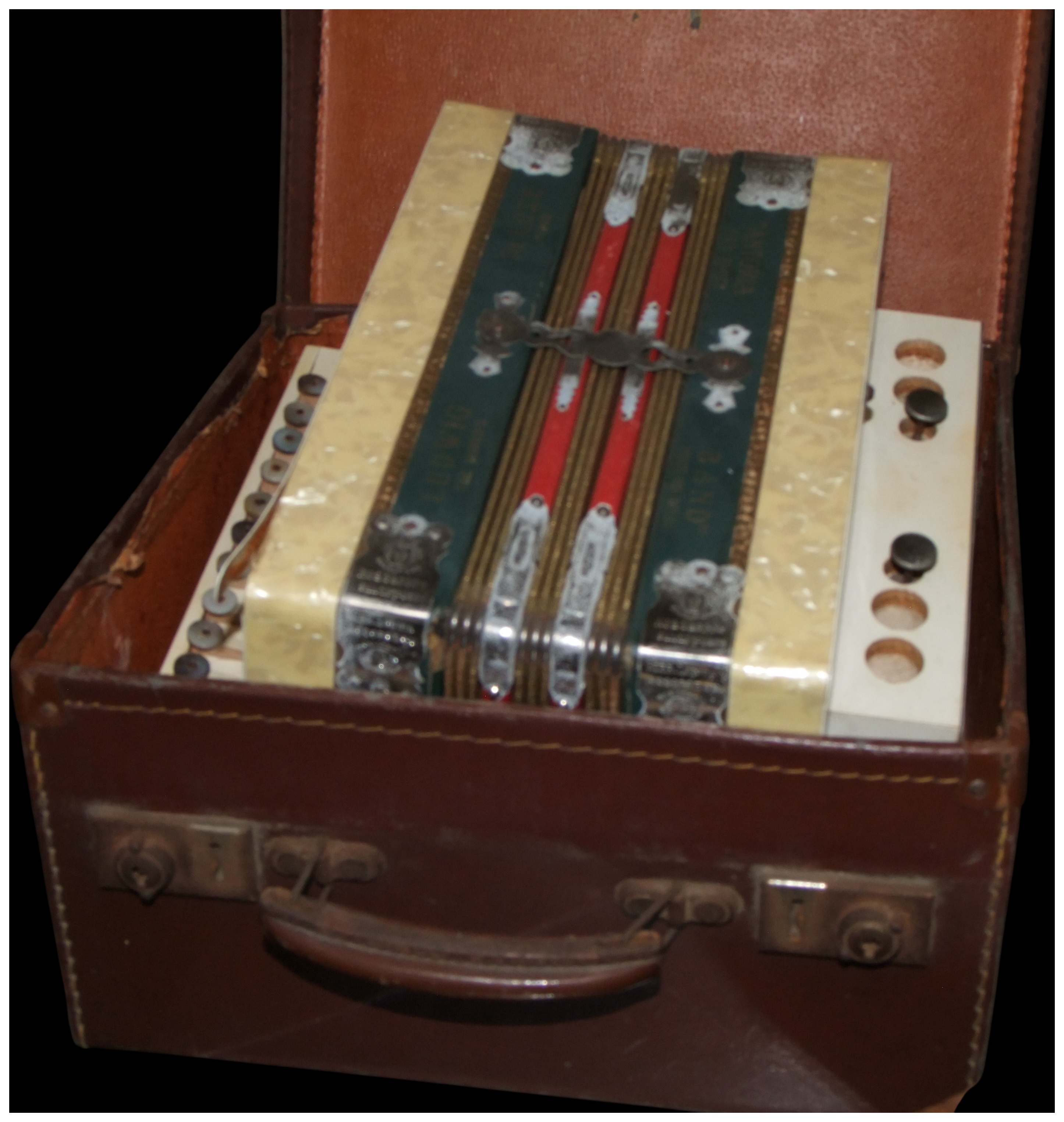 A mid-20th-century Diamond and Victory Brand diatonic button accordion with case