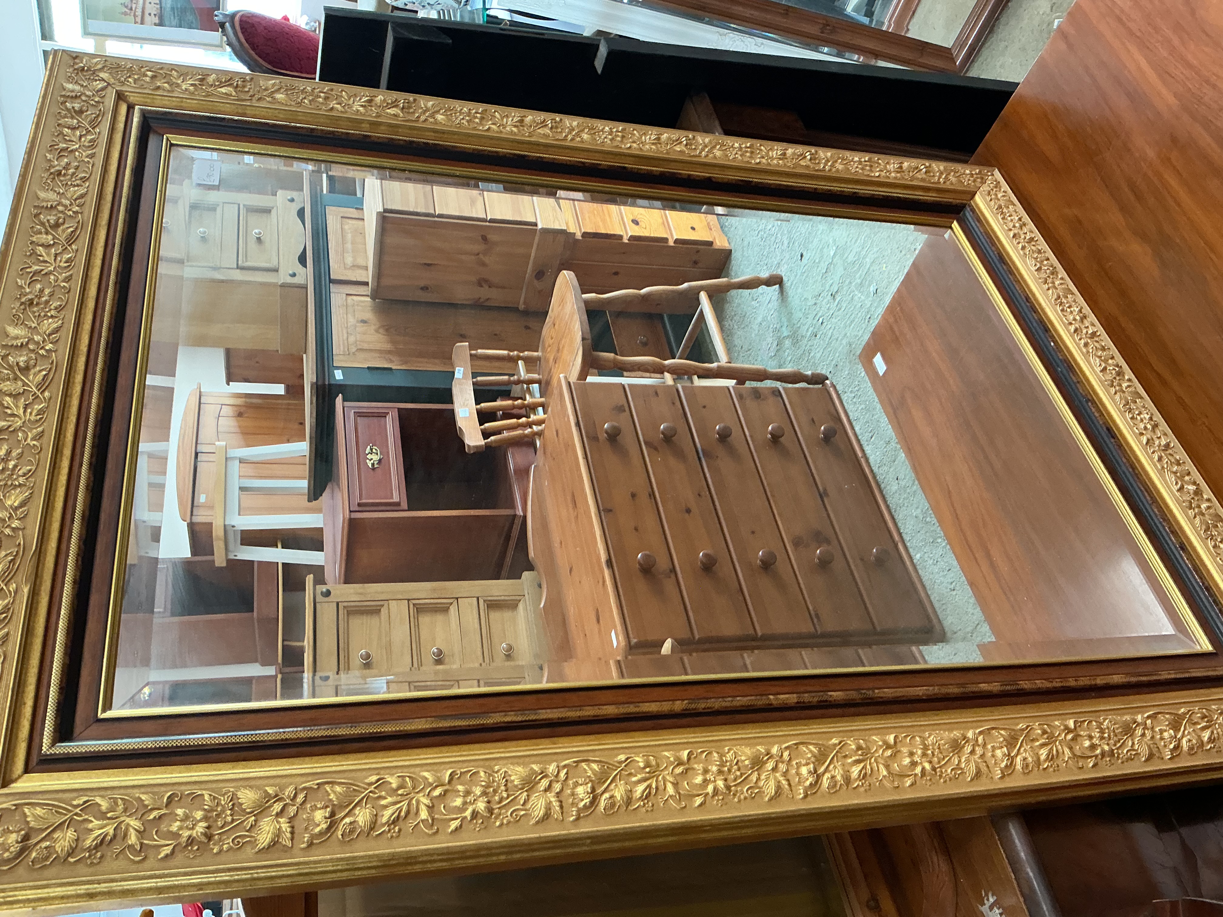 A Large Victorian Style Ornate Gilt and Stained Hardwood Bevelled Wall Mirror
