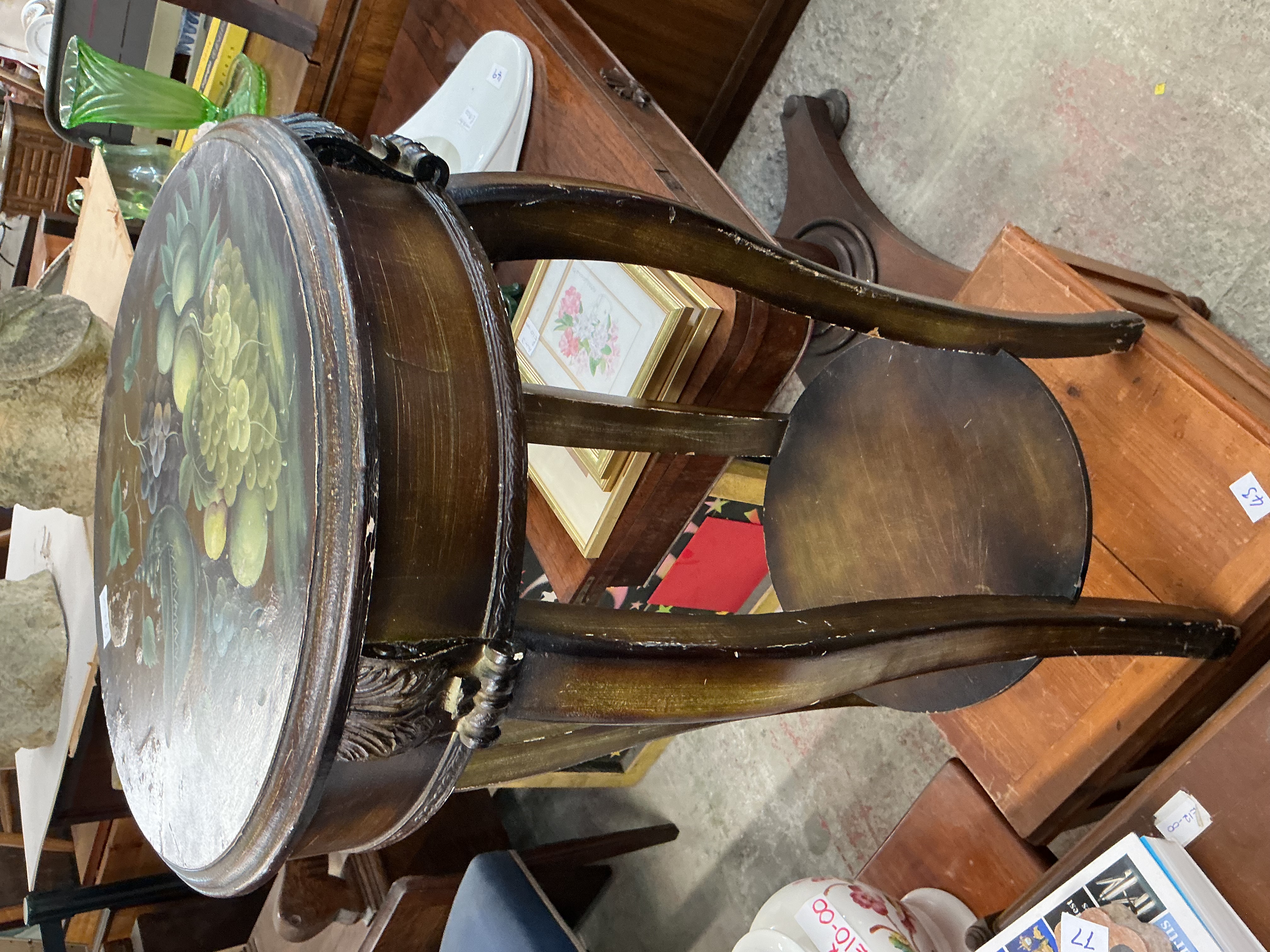 A decorative two-tier occasional table with hand-painted fruit still-life
