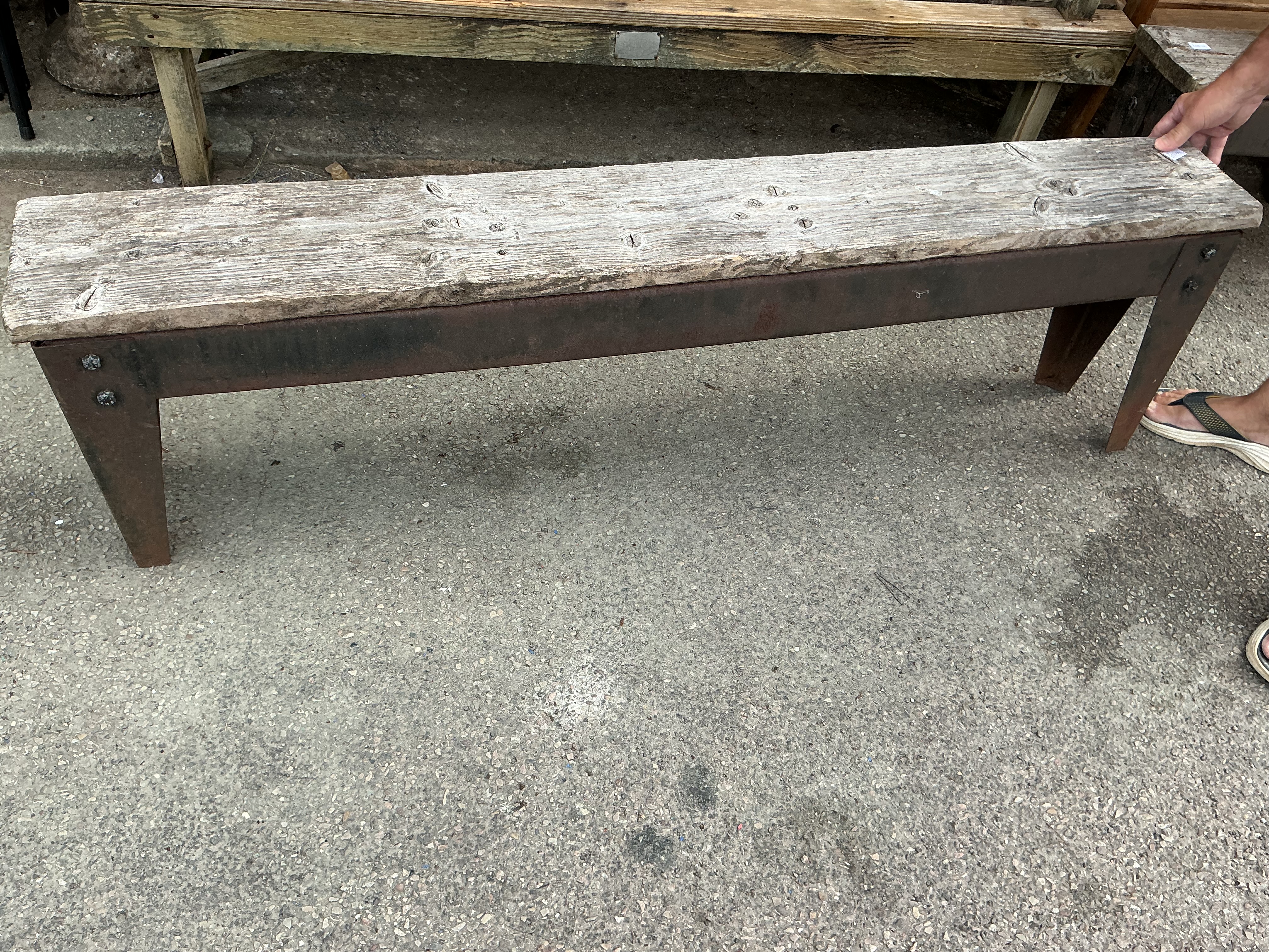 A rustic industrial reclaimed timber and metal bench
