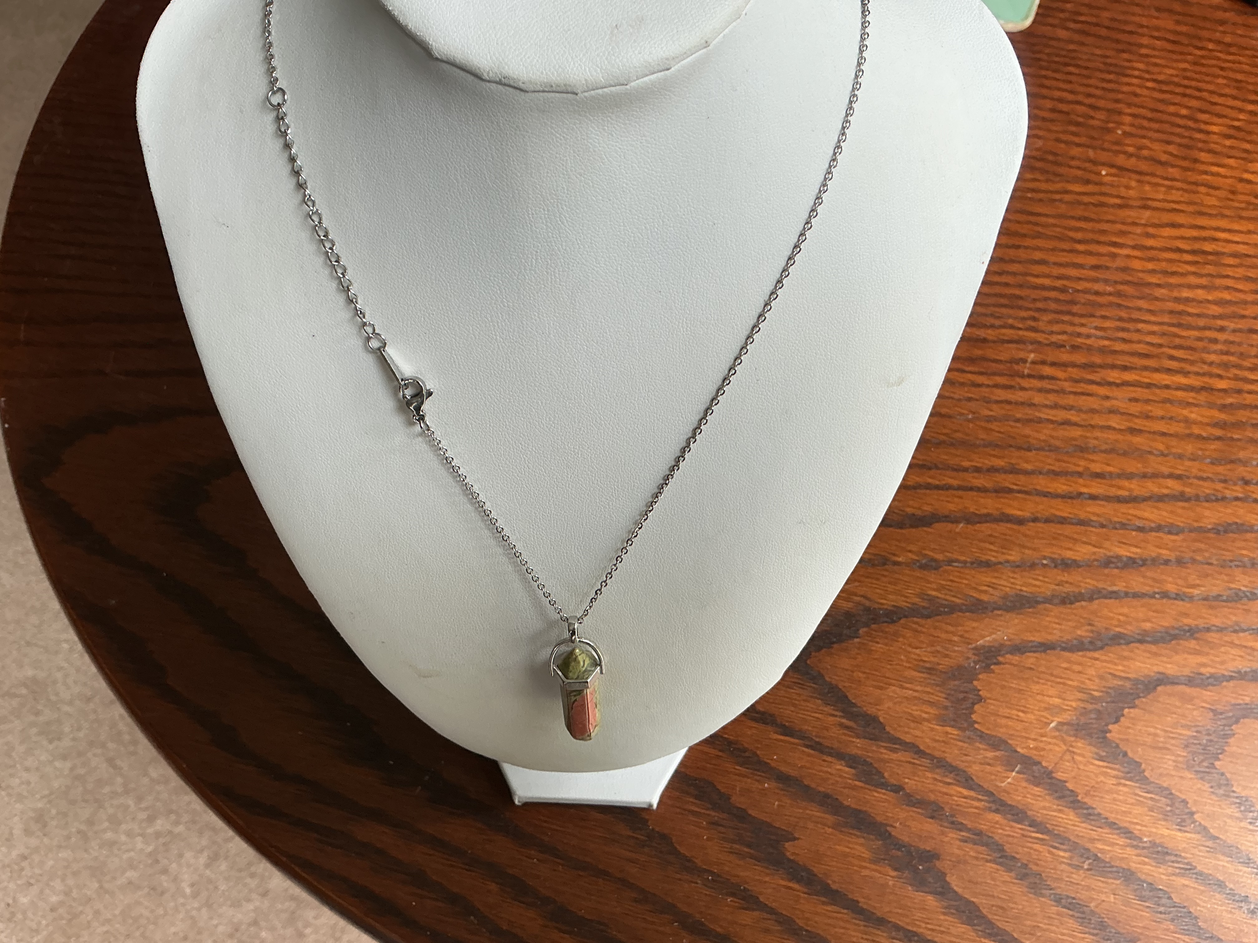 August. Unakite point pendant on a silvertone trace link chain