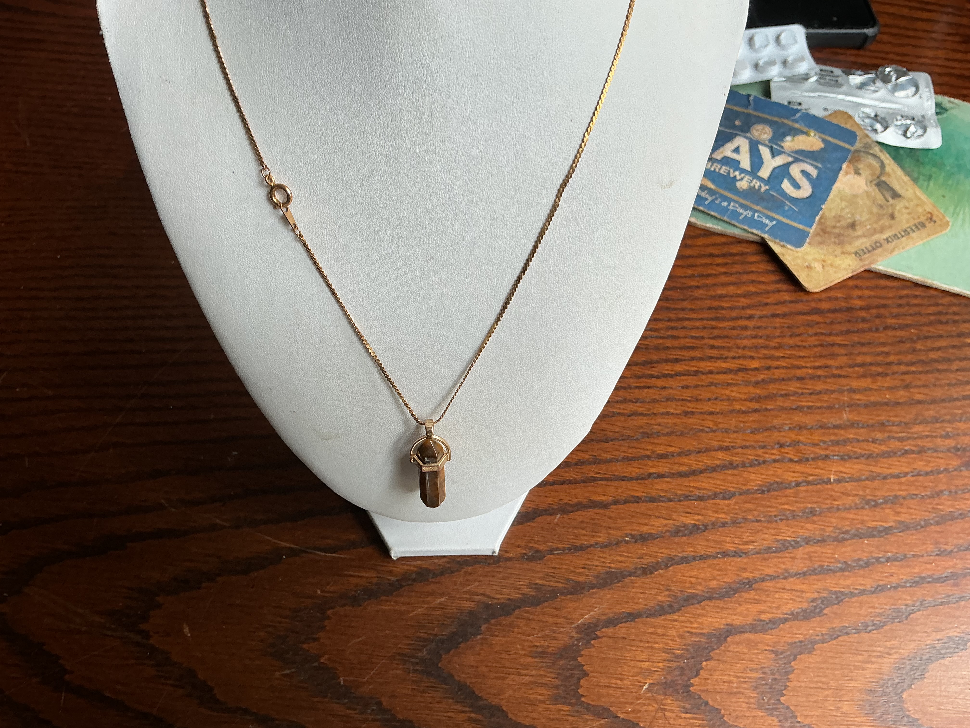 January. A Yellow Metal and Tiger's Eye Point Pendant Necklace
