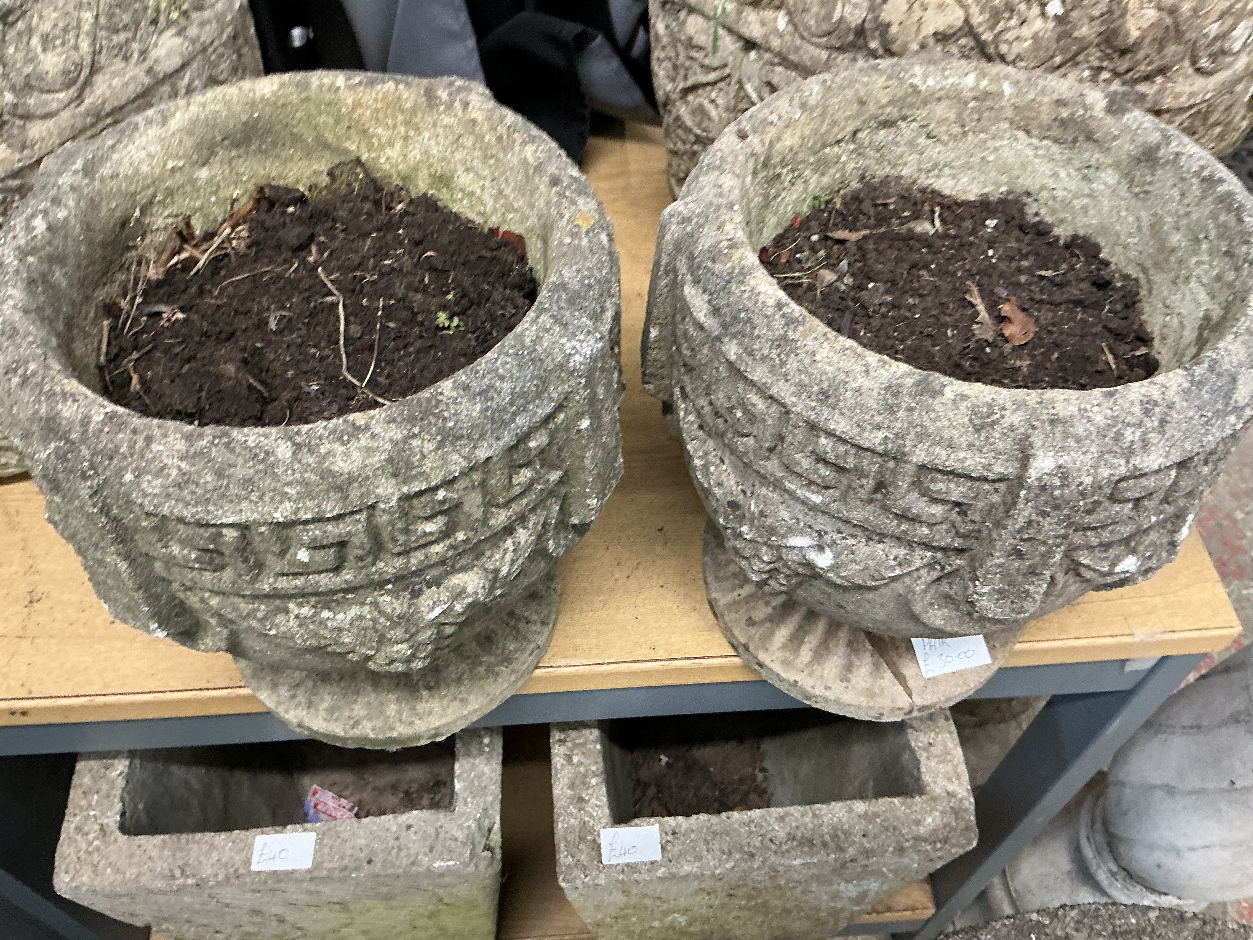 A Collection of Weathered Reconstituted Stone Garden Planters and Urns