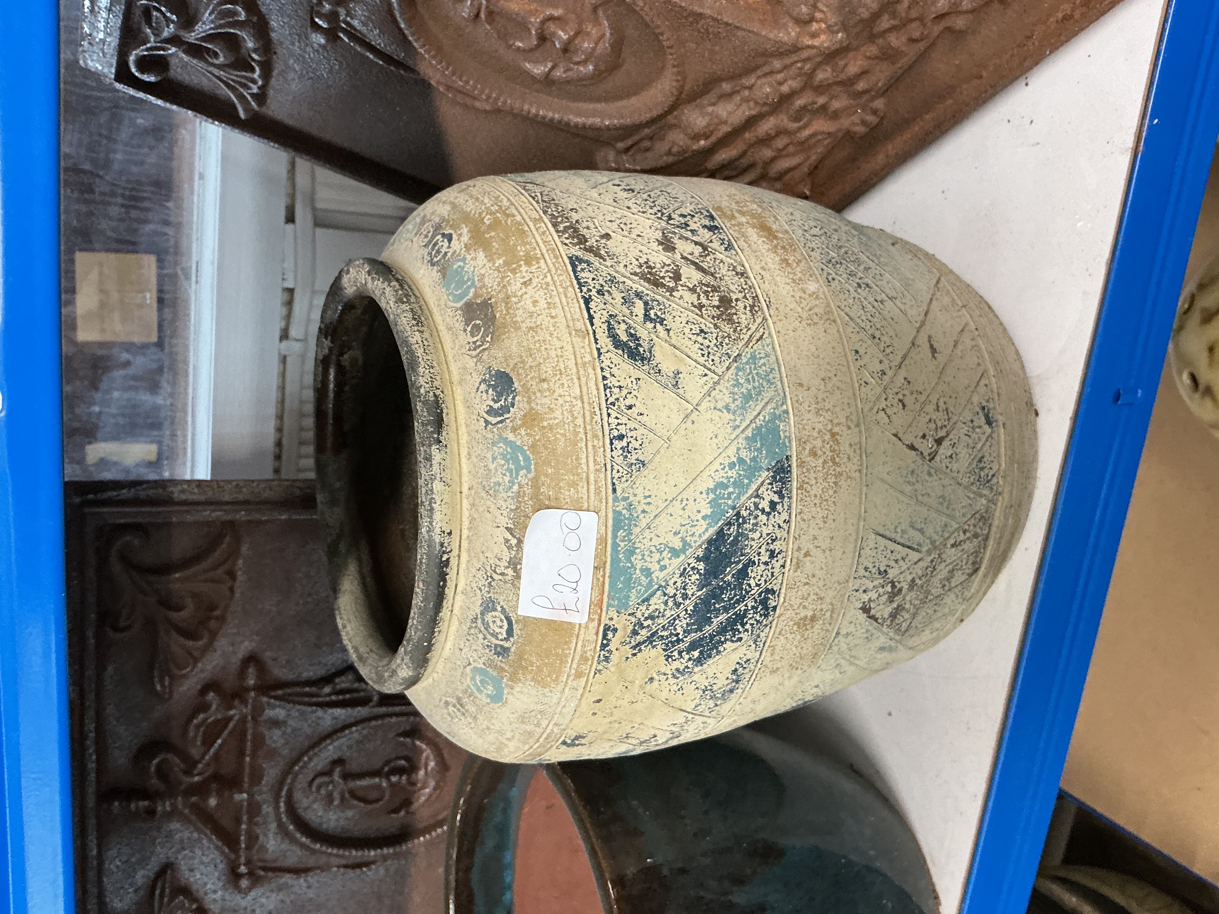 A rustic banded stoneware jar with incised chevron decoration