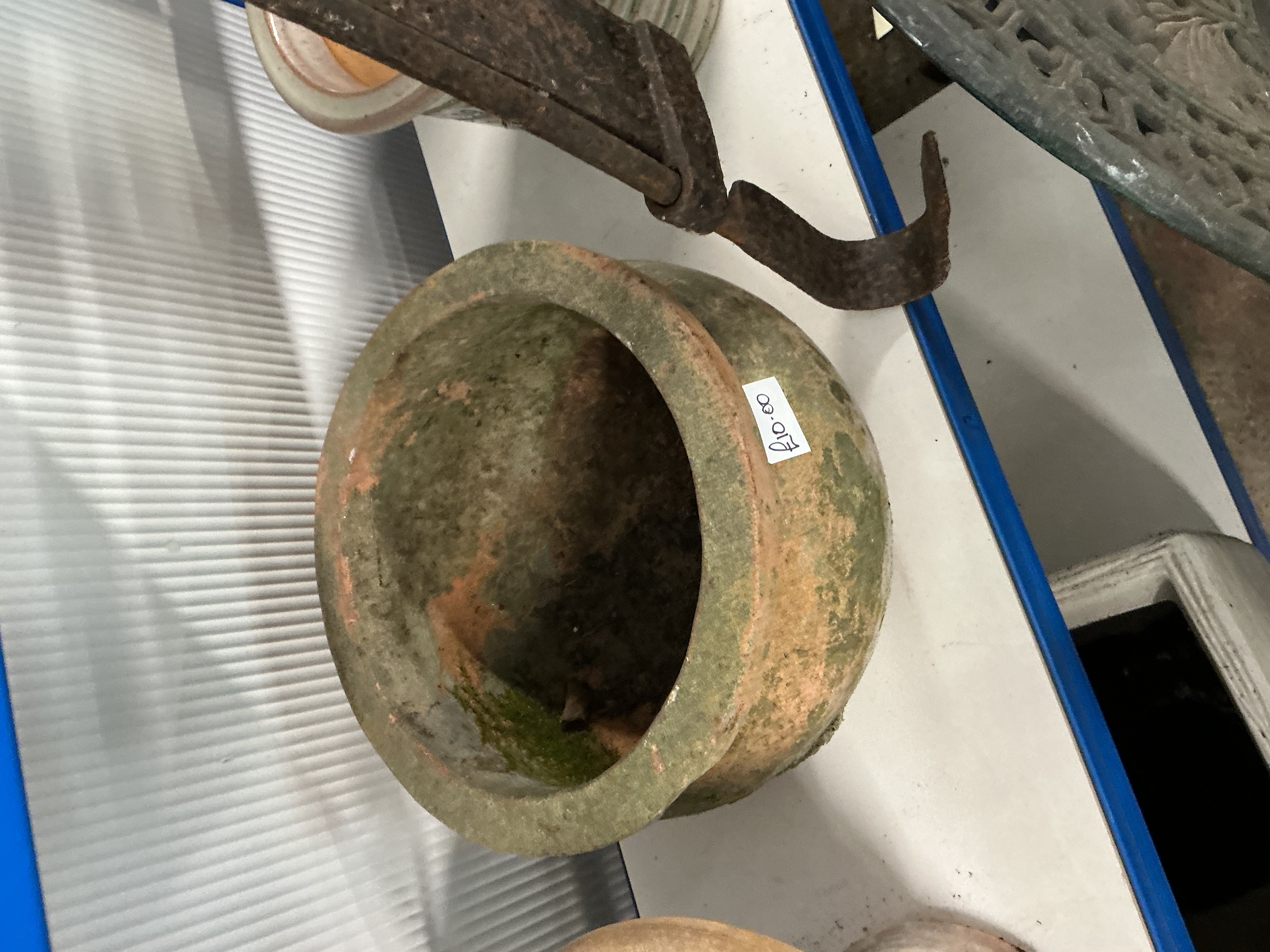 A weathered earthenware garden planter or shallow crock