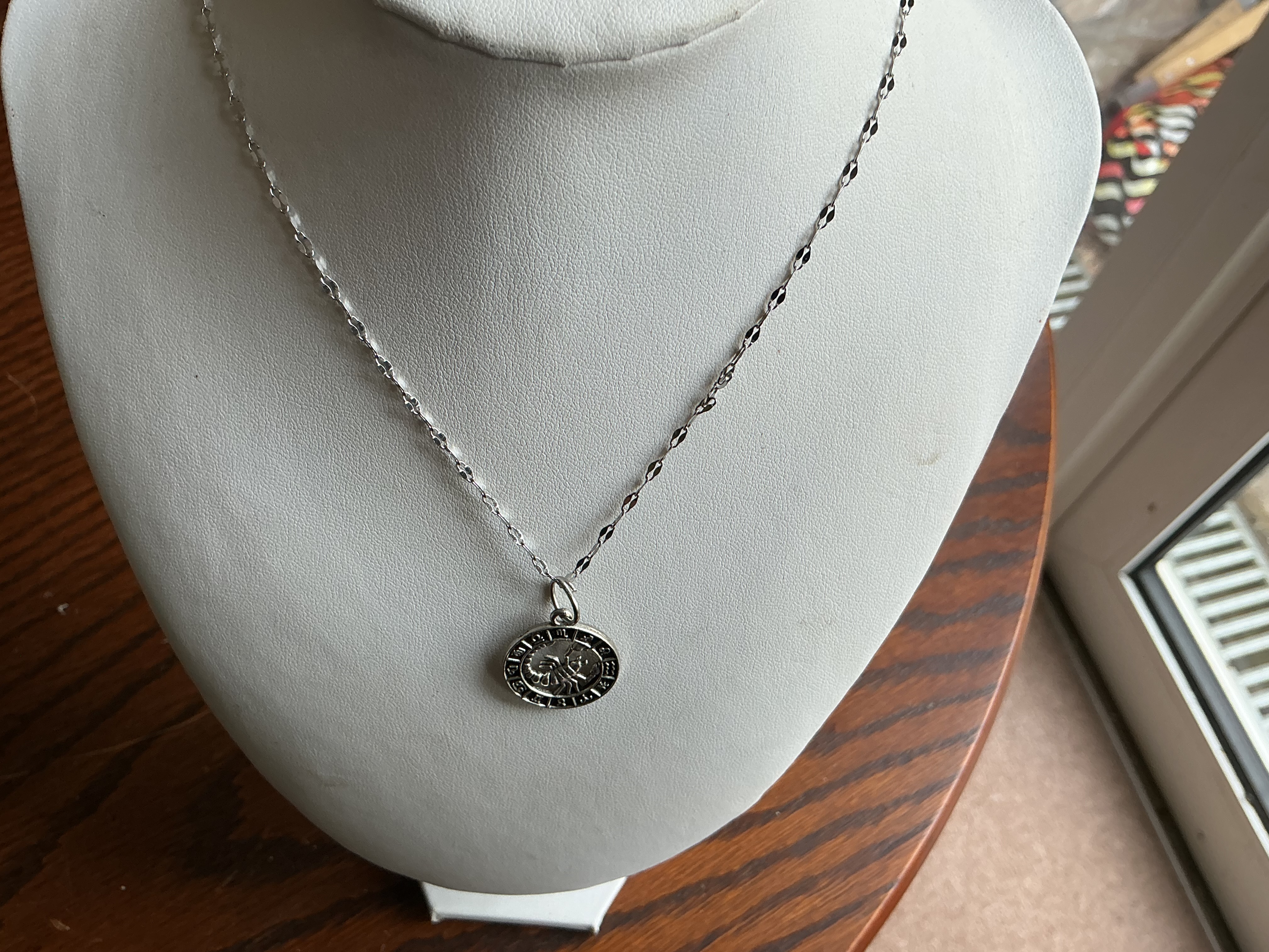 A Scorpio Zodiac Medallion Pendant on a Mirror-Link Chain