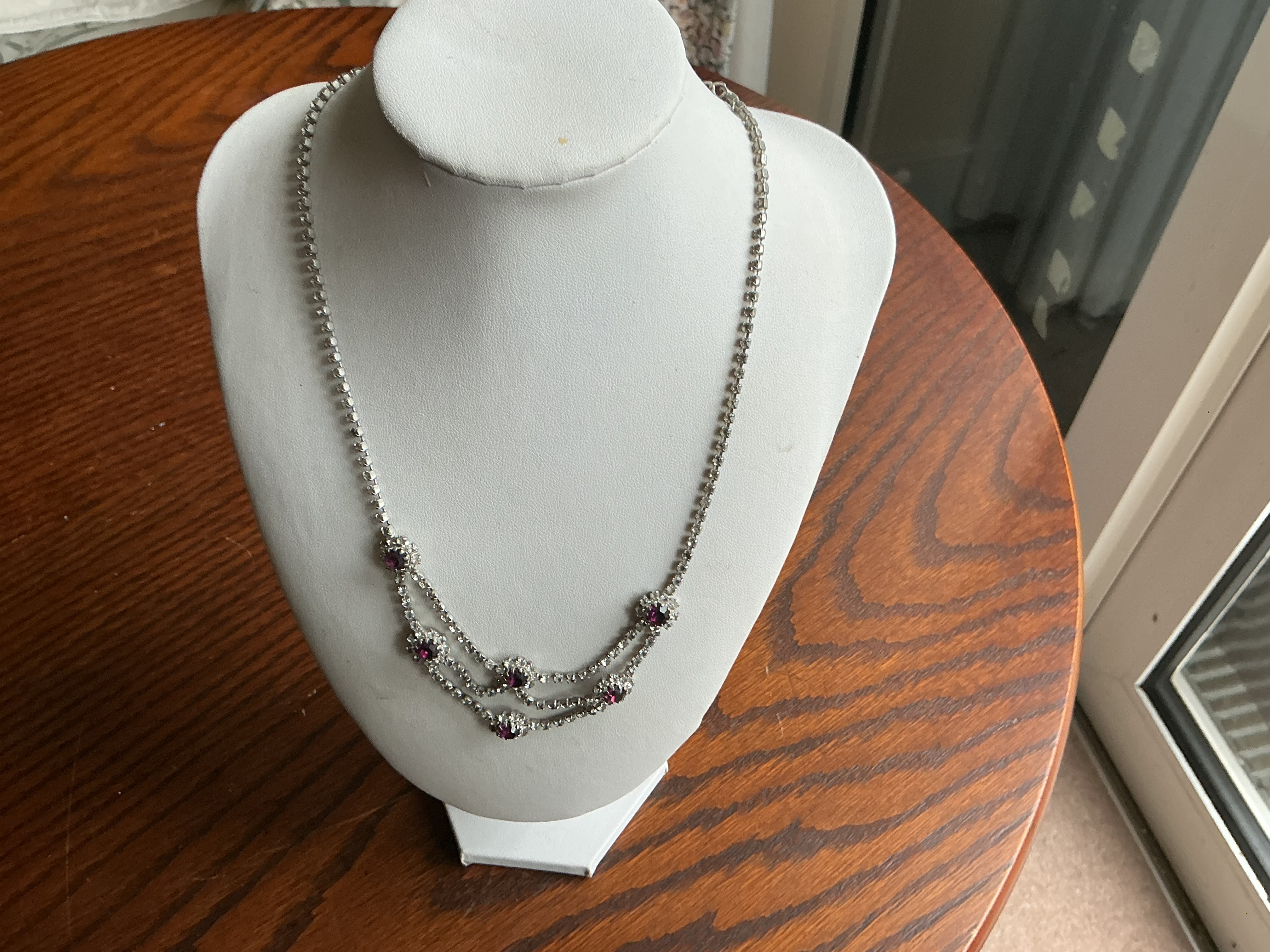 A Vintage Mid-Century Silver-Tone Rhinestone Double-Swag Bib Necklace with Purple Accents