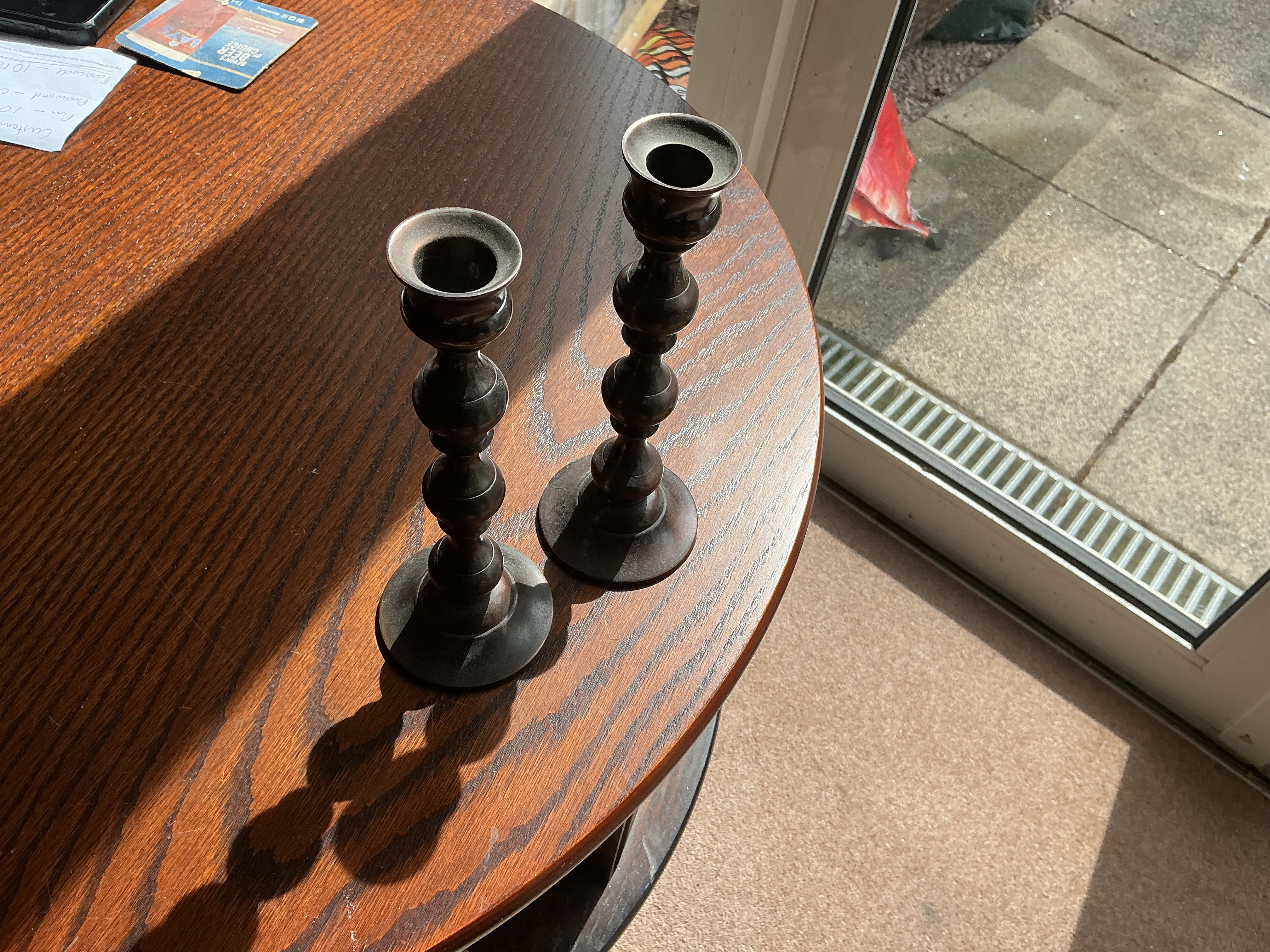 A Pair of Patinated Cast Metal Baluster Form Candlesticks