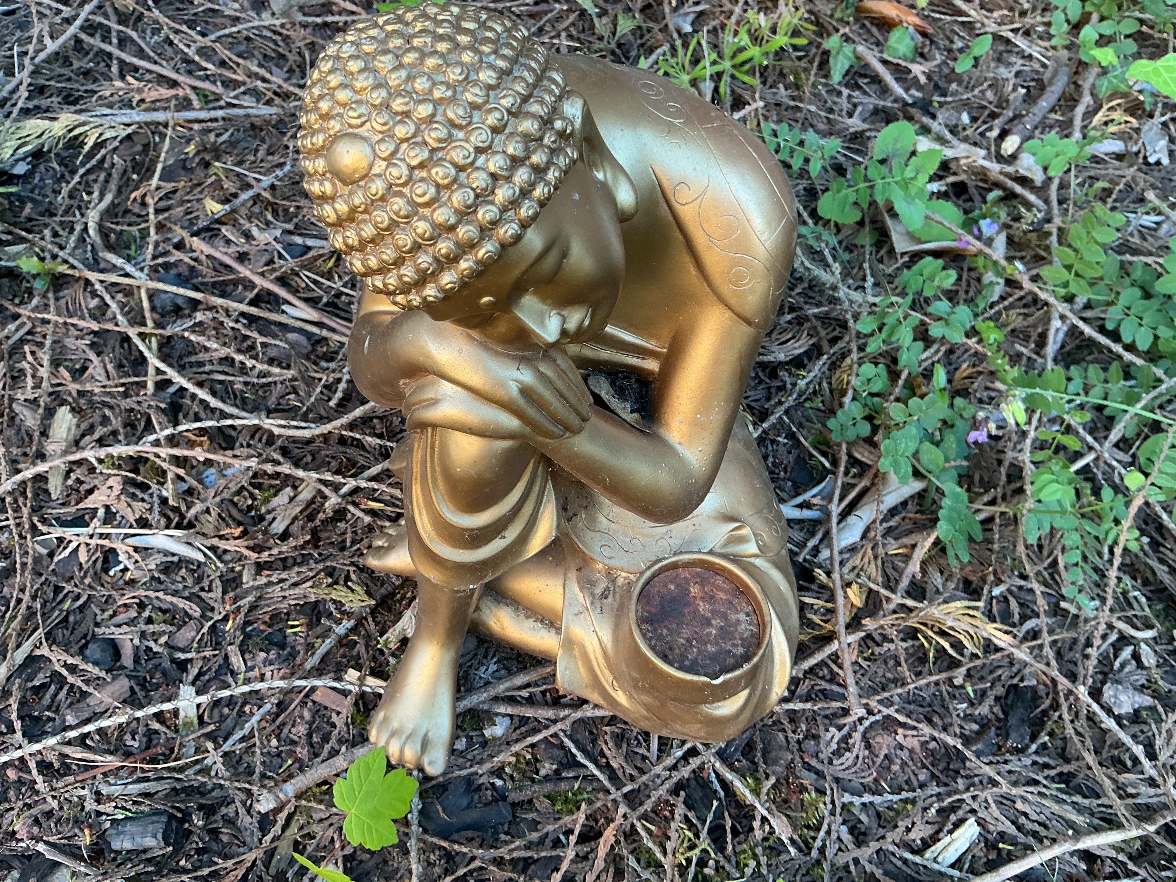 A Cast Composite Garden Statue of a Resting Buddha with Votive Holder